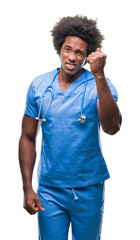 Sticker - Afro american surgeon doctor man over isolated background angry and mad raising fist frustrated and furious while shouting with anger. Rage and aggressive concept.