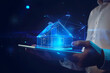 Man holding the neon house outline, real estate concept