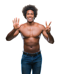 Canvas Print - Afro american shirtless man showing nude body over isolated background showing and pointing up with fingers number seven while smiling confident and happy.