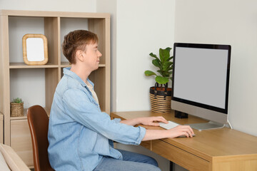 Poster - Young man using computer at desk in office