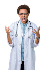 Wall Mural - Young african american doctor woman wearing medical coat over isolated background crazy and mad shouting and yelling with aggressive expression and arms raised. Frustration concept.