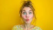 © Emre Akkoyun - Young woman making funny face on yellow background, copy space