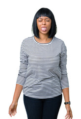 Sticker - Beautiful young african american woman wearing stripes sweater over isolated background sticking tongue out happy with funny expression. Emotion concept.