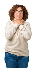 Canvas Print - Beautiful middle ager senior woman wearing turtleneck sweater and glasses over isolated background shouting and suffocate because painful strangle. Health problem. Asphyxiate and suicide concept.