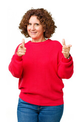 Poster - Beautiful middle ager senior woman red winter sweater over isolated background pointing fingers to camera with happy and funny face. Good energy and vibes.