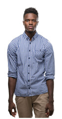 Wall Mural - Young african american man wearing blue shirt with serious expression on face. Simple and natural looking at the camera.