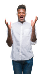 Canvas Print - Young african american man over isolated background crazy and mad shouting and yelling with aggressive expression and arms raised. Frustration concept.