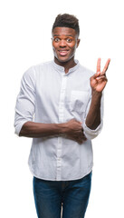 Wall Mural - Young african american man over isolated background smiling with happy face winking at the camera doing victory sign. Number two.
