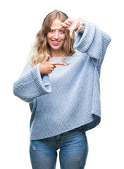 Poster - Beautiful young blonde woman wearing winter sweater over isolated background smiling making frame with hands and fingers with happy face. Creativity and photography concept.