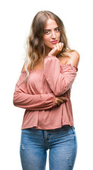 Poster - Beautiful young blonde woman over isolated background looking confident at the camera with smile with crossed arms and hand raised on chin. Thinking positive.