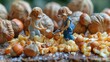 A miniature person chops nuts. A miniature person breaks hazelnut kernels. The hazelnut is isolated.