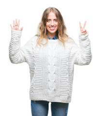 Sticker - Beautiful young blonde woman wearing winter sweater over isolated background showing and pointing up with fingers number seven while smiling confident and happy.