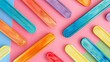 Colorful wooden popsicle sticks laid out on a pastel backdrop