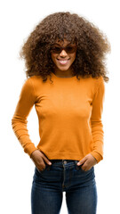 Sticker - African american woman wearing an orage sweater with a happy face standing and smiling with a confident smile showing teeth