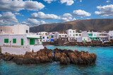 Fototapeta Desenie - View of Punta Mujeres Village with white houses, on the coast of Lanzarote Island at the foot of the volcanic mountain in Canary Islands, Spain