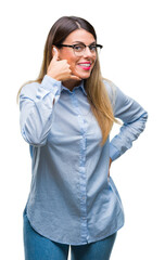 Wall Mural - Young beautiful business woman wearing glasses over isolated background smiling doing phone gesture with hand and fingers like talking on the telephone. Communicating concepts.