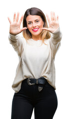 Canvas Print - Young beautiful woman casual white sweater over isolated background showing and pointing up with fingers number ten while smiling confident and happy.