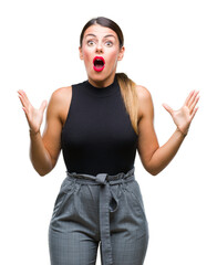 Wall Mural - Young beautiful elegant business woman over isolated background crazy and mad shouting and yelling with aggressive expression and arms raised. Frustration concept.
