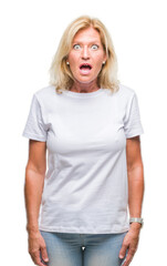 Sticker - Middle age blonde woman over isolated background afraid and shocked with surprise expression, fear and excited face.