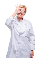 Sticker - Middle age blonde therapist woman wearing white coat over isolated background doing ok gesture with hand smiling, eye looking through fingers with happy face.