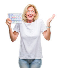 Sticker - Middle age blonde woman holding menstruation calendar ver isolated background very happy and excited, winner expression celebrating victory screaming with big smile and raised hands