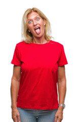 Sticker - Middle age blonde woman over isolated background sticking tongue out happy with funny expression. Emotion concept.