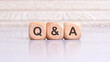 concept of Q and A word on wooden cubes, wooden background