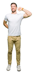 Poster - Handsome man wearing casual white t-shirt stretching back, tired and relaxed, sleepy and yawning for early morning