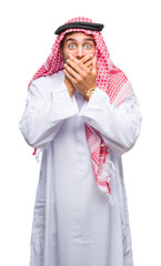 Canvas Print - Young handsome man wearing keffiyeh over isolated background shocked covering mouth with hands for mistake. Secret concept.