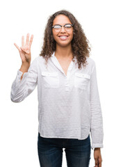 Wall Mural - Beautiful young hispanic woman showing and pointing up with fingers number four while smiling confident and happy.