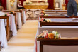 church aisle elegantly adorned with floral arrangements for a wedding