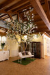 indoor wedding venue decorated with artificial cherry blossom trees