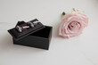 elegant cufflinks in box with pink rose boutonniere on side