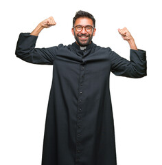 Sticker - Adult hispanic catholic priest man over isolated background showing arms muscles smiling proud. Fitness concept.