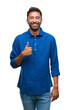 © Krakenimages.com - Adult hispanic man over isolated background doing happy thumbs up gesture with hand. Approving expression looking at the camera with showing success.