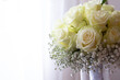 fresh bouquet of white roses with baby's breath on display