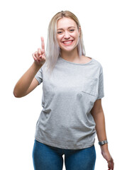 Poster - Young blonde woman over isolated background showing and pointing up with finger number one while smiling confident and happy.