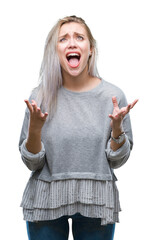 Sticker - Young blonde woman over isolated background crazy and mad shouting and yelling with aggressive expression and arms raised. Frustration concept.