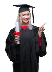 Sticker - Young blonde woman wearing graduate uniform holding degree over isolated background very happy pointing with hand and finger to the side