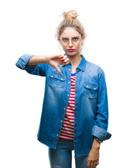 Canvas Print - Young beautiful blonde woman wearing glasses over isolated background looking unhappy and angry showing rejection and negative with thumbs down gesture. Bad expression.