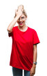 Young beautiful blonde woman wearing red t-shirt and glasses over isolated background surprised with hand on head for mistake, remember error. Forgot, bad memory concept.