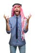 © Krakenimages.com - Young handsome arabian business man wearing keffiyeh over isolated background crazy and mad shouting and yelling with aggressive expression and arms raised. Frustration concept.