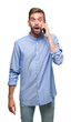 © Krakenimages.com - Young handsome man speaking on the phone over isolated background scared in shock with a surprise face, afraid and excited with fear expression