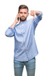 © Krakenimages.com - Young handsome man speaking on the phone over isolated background with angry face, negative sign showing dislike with thumbs down, rejection concept