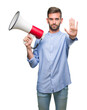 © Krakenimages.com - Young handsome man yelling through megaphone over isolated background with open hand doing stop sign with serious and confident expression, defense gesture