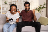 Fototapeta  - Couple Enjoying Video Game Together On Couch At Home, Competitive Fun, Leisure Activity