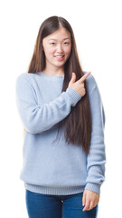 Poster - Young Chinese woman over isolated background cheerful with a smile of face pointing with hand and finger up to the side with happy and natural expression on face looking at the camera.