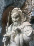 Fototapeta Paryż - Marble statue guards cave iin Hoa Nghiem Caves complex, near Da Nang, Vietnam