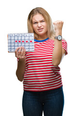 Poster - Young caucasian woman holding menstruation calendar over isolated background annoyed and frustrated shouting with anger, crazy and yelling with raised hand, anger concept