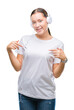 © Krakenimages.com - Young caucasian woman listening to music wearing headphones over isolated background looking confident with smile on face, pointing oneself with fingers proud and happy.